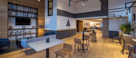 A modern interior with a bar area, seating, and a TV.