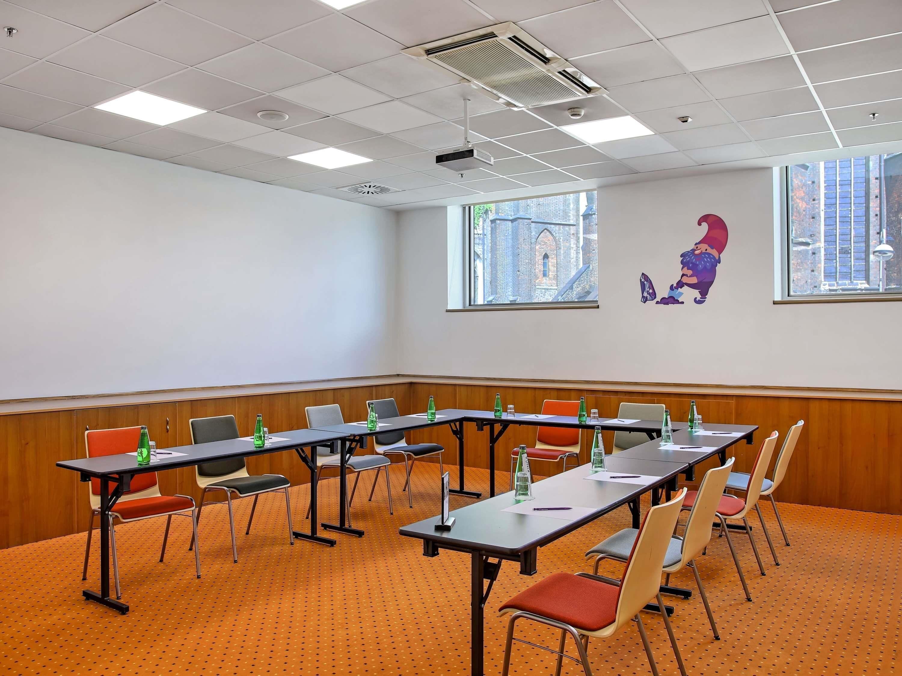 A conference room with tables, chairs, and a large window with a city view.