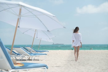 On the beach, white sand, beach cabanas, sun loungers at The Ritz-Carlton, South Beach