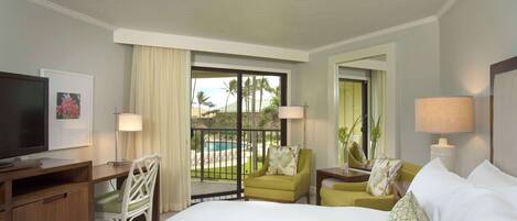 A hotel room with a bed, a desk, a television, a chair, a lamp, and a view of a pool and palm trees.