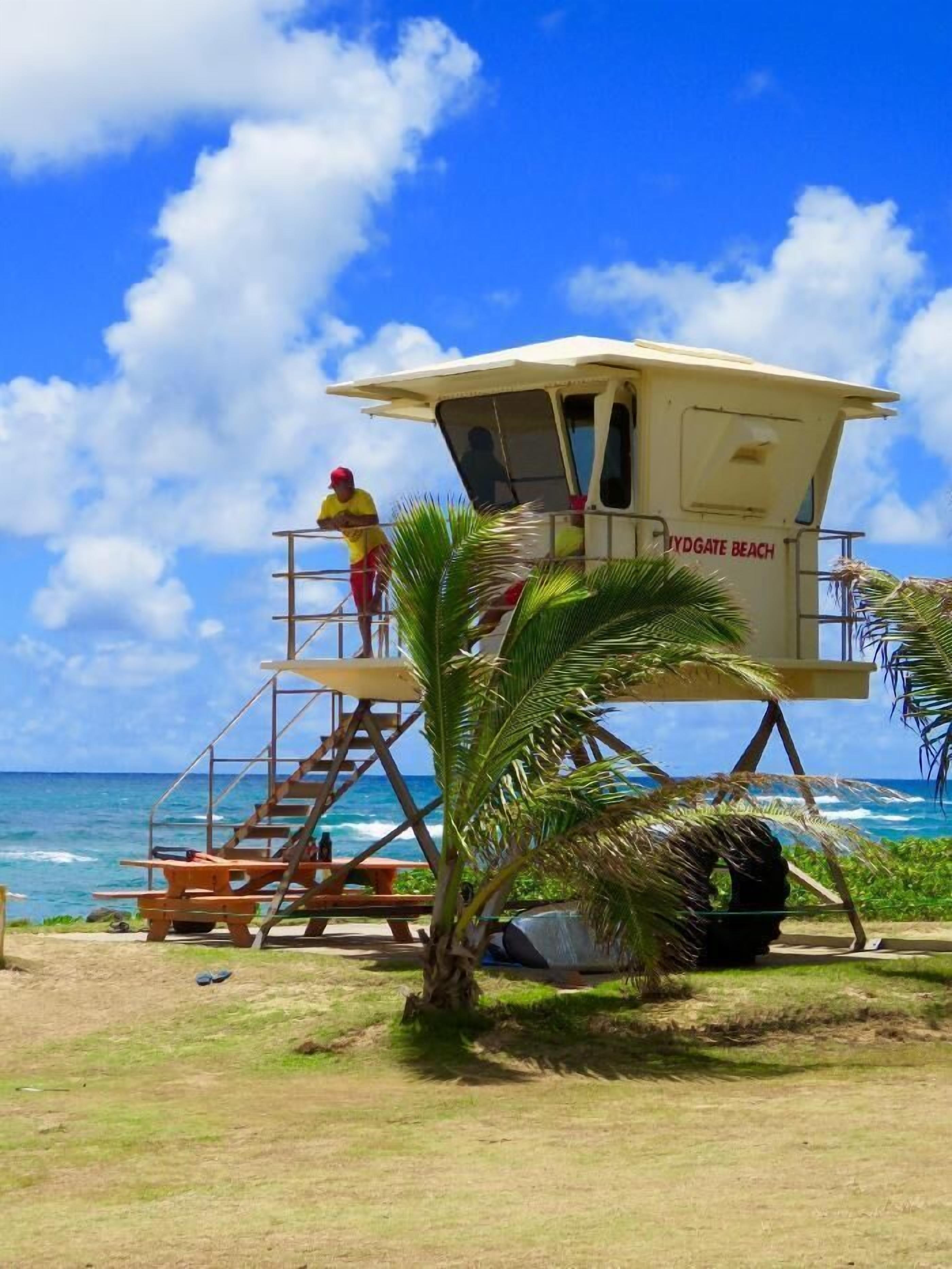 A lifeguard tower at a beach with a clear view of the ocean.