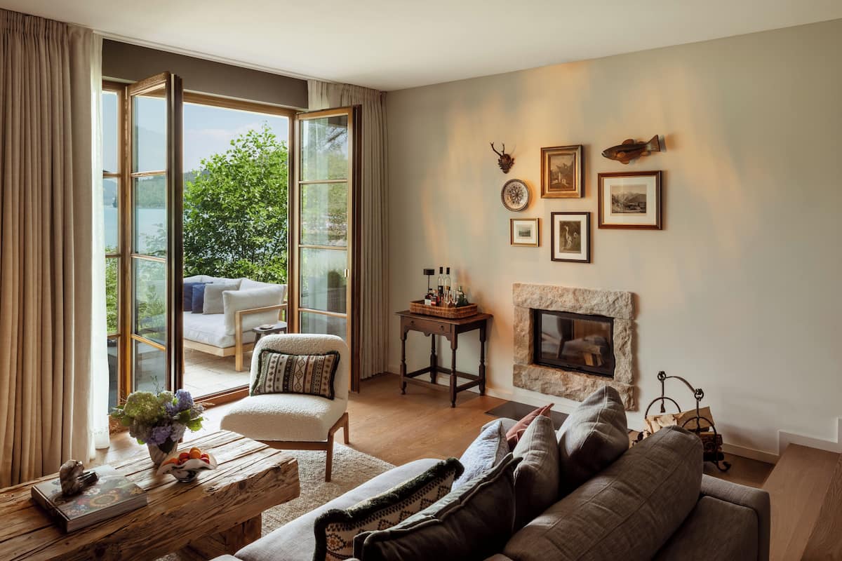 A living room with a fireplace, a sofa, a chair, and a coffee table.