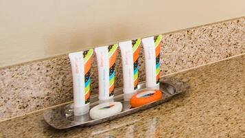 A tray with dental hygiene products including toothpaste and a dental floss tube.