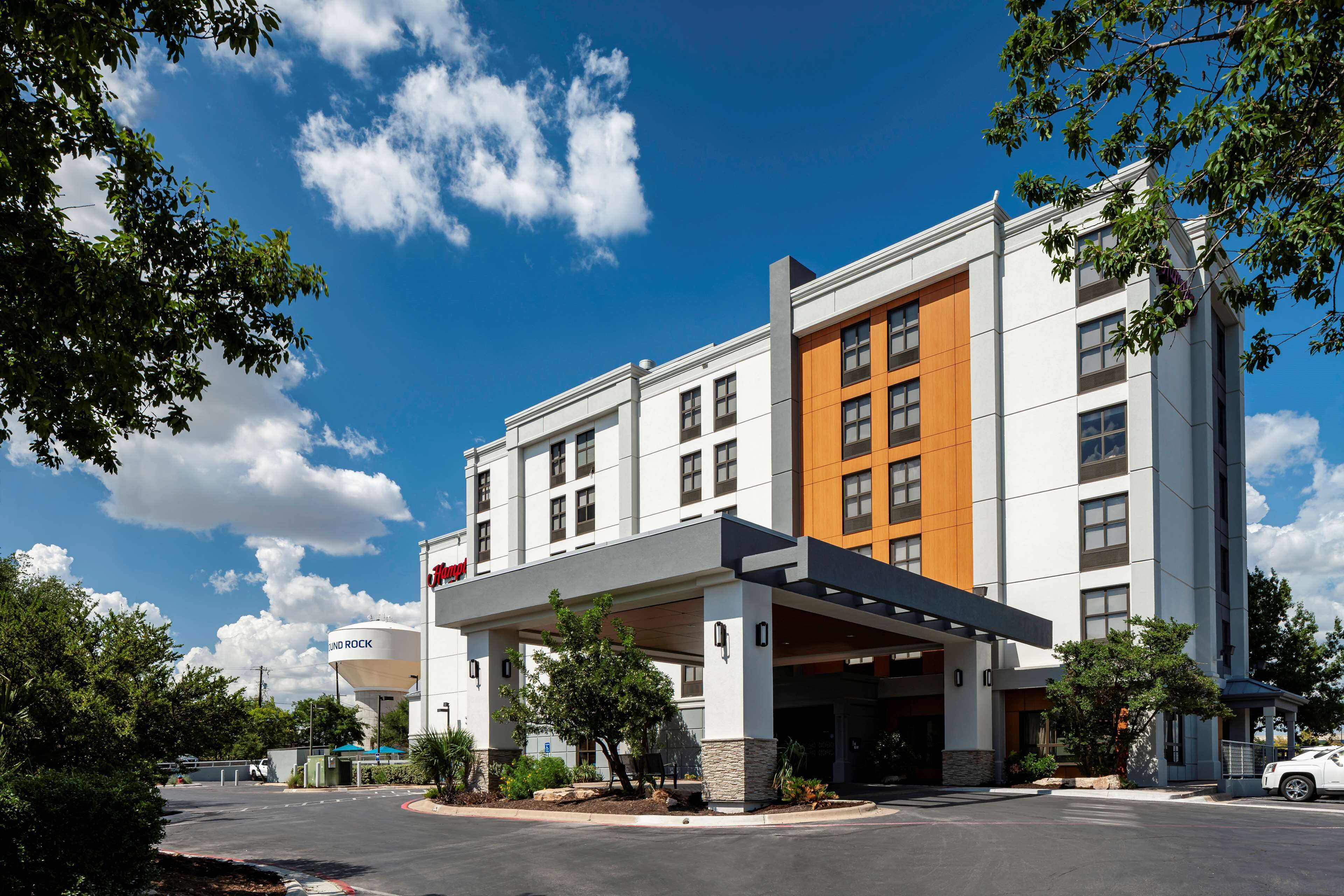 Un hôtel moderne doté d’une entrée couverte, de plusieurs étages et d’une enseigne « Holiday Inn » bien visible.