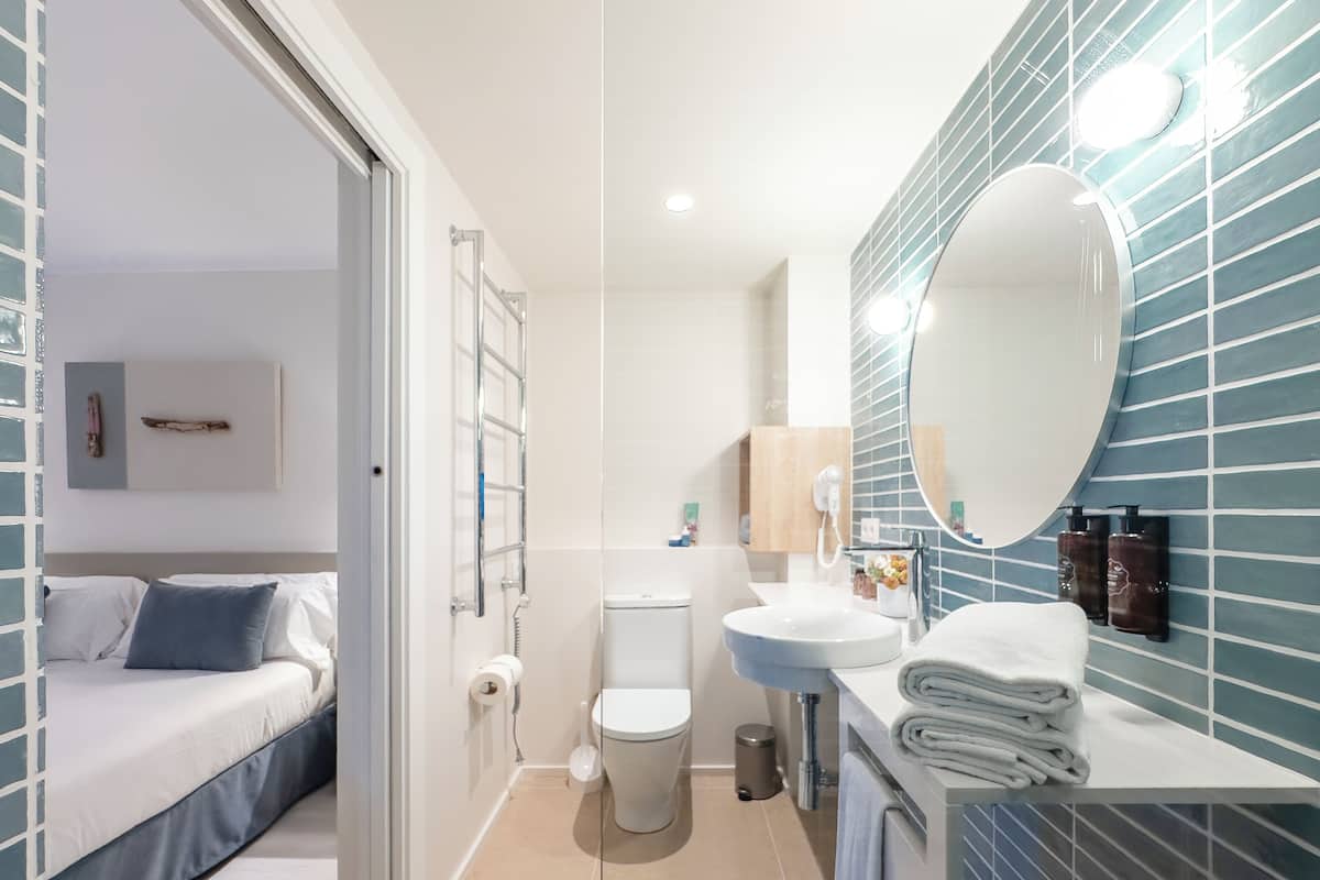 shower, rainfall showerhead, hair dryer, towels