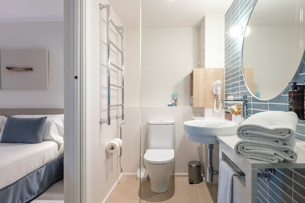 shower, rainfall showerhead, hair dryer, towels