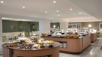 A buffet area with various food items and a seating area with chairs.