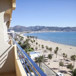 Enjoy breathtaking views of the beach and surrounding landscape from this balcony.