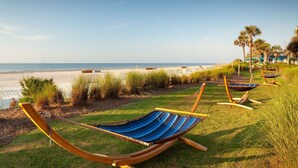 A beach with hammocks and palm trees. - Hilton Beachfront Resort & Spa Hilton Head Island (Hilton Head Island)
