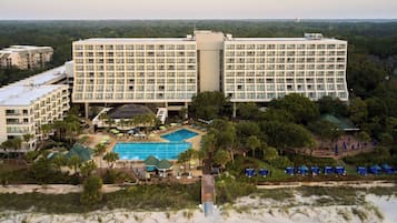 Experience the tranquility of a coastal retreat with a balcony overlooking the ocean and access to a swimming pool.