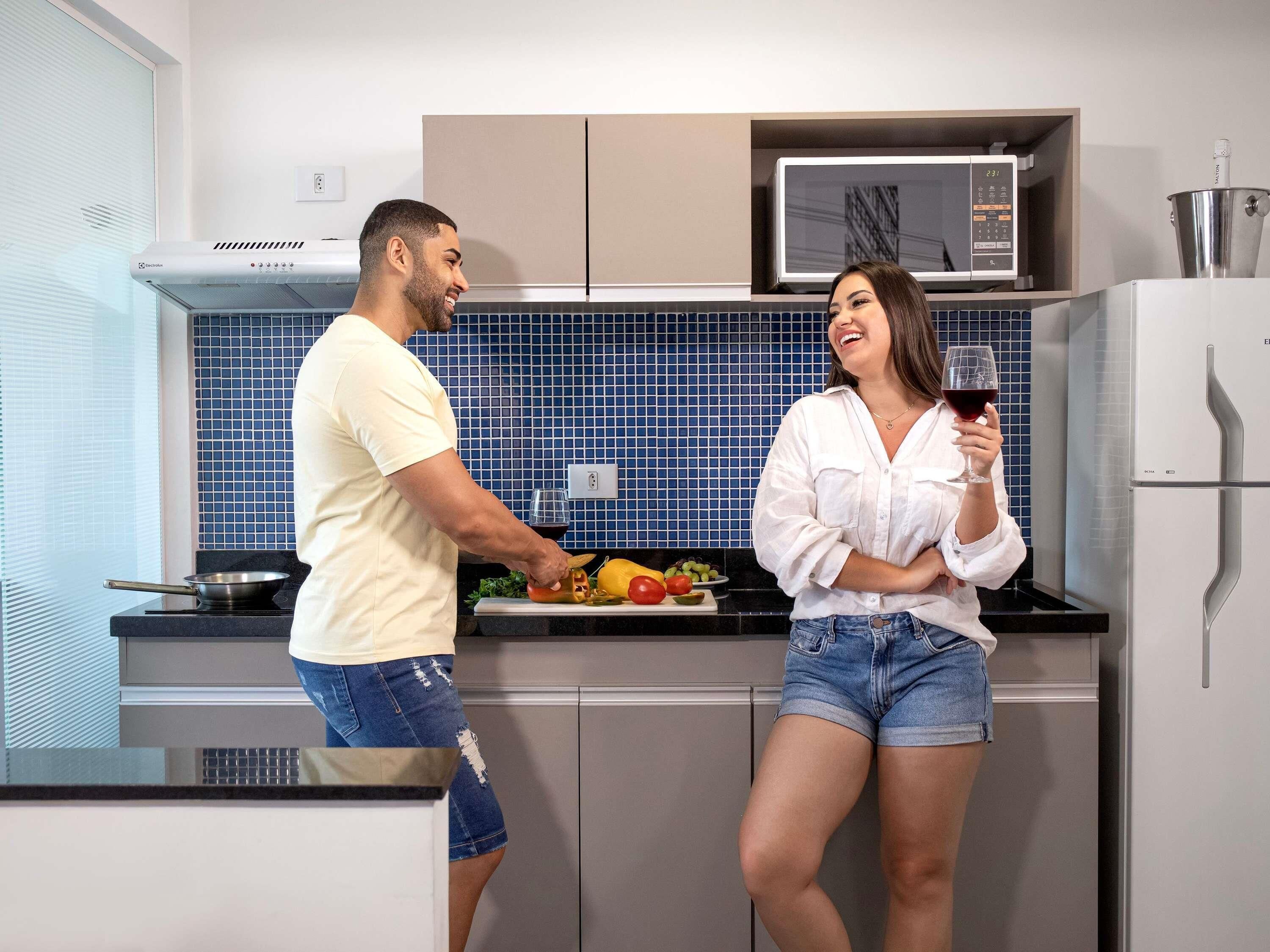 A modern kitchen with a microwave, a stove, and a refrigerator.