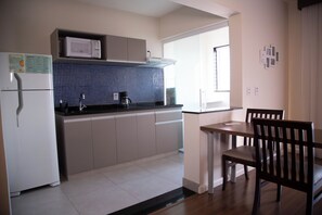 Full-sized fridge, microwave, stovetop, cookware/dishes/utensils