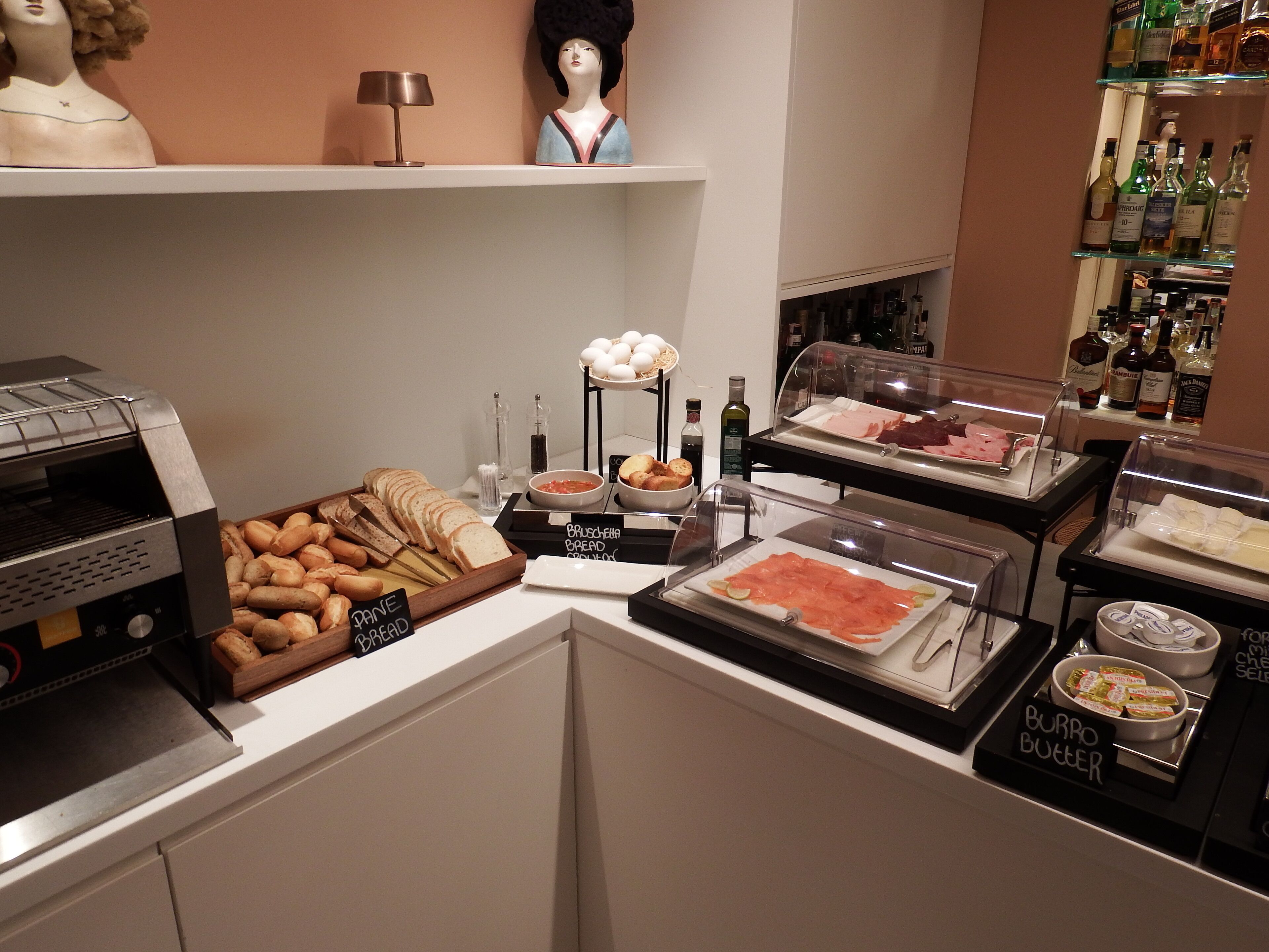 A buffet with various food items and a grill.