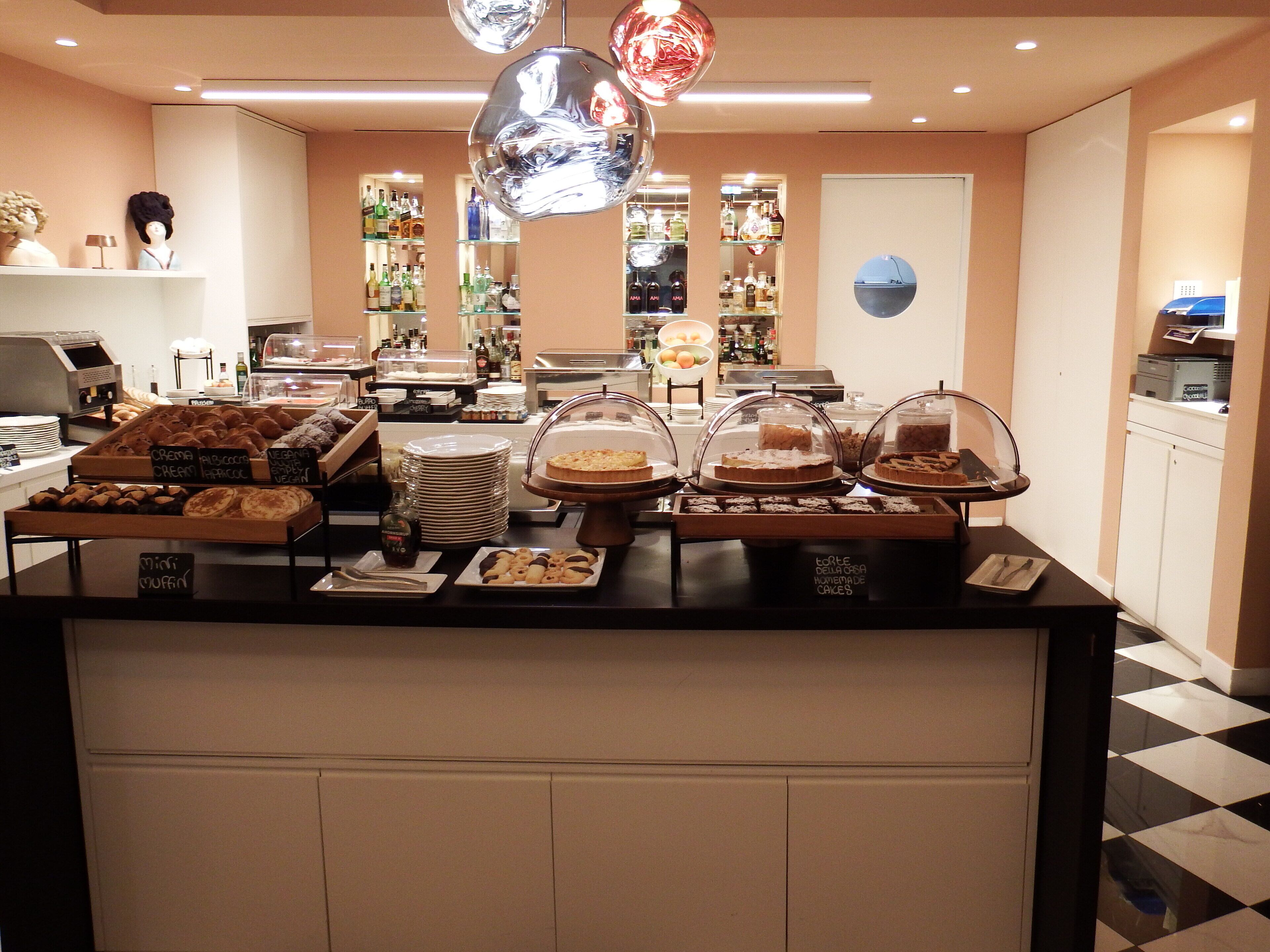 A buffet area with various food items and a selection of beverages.