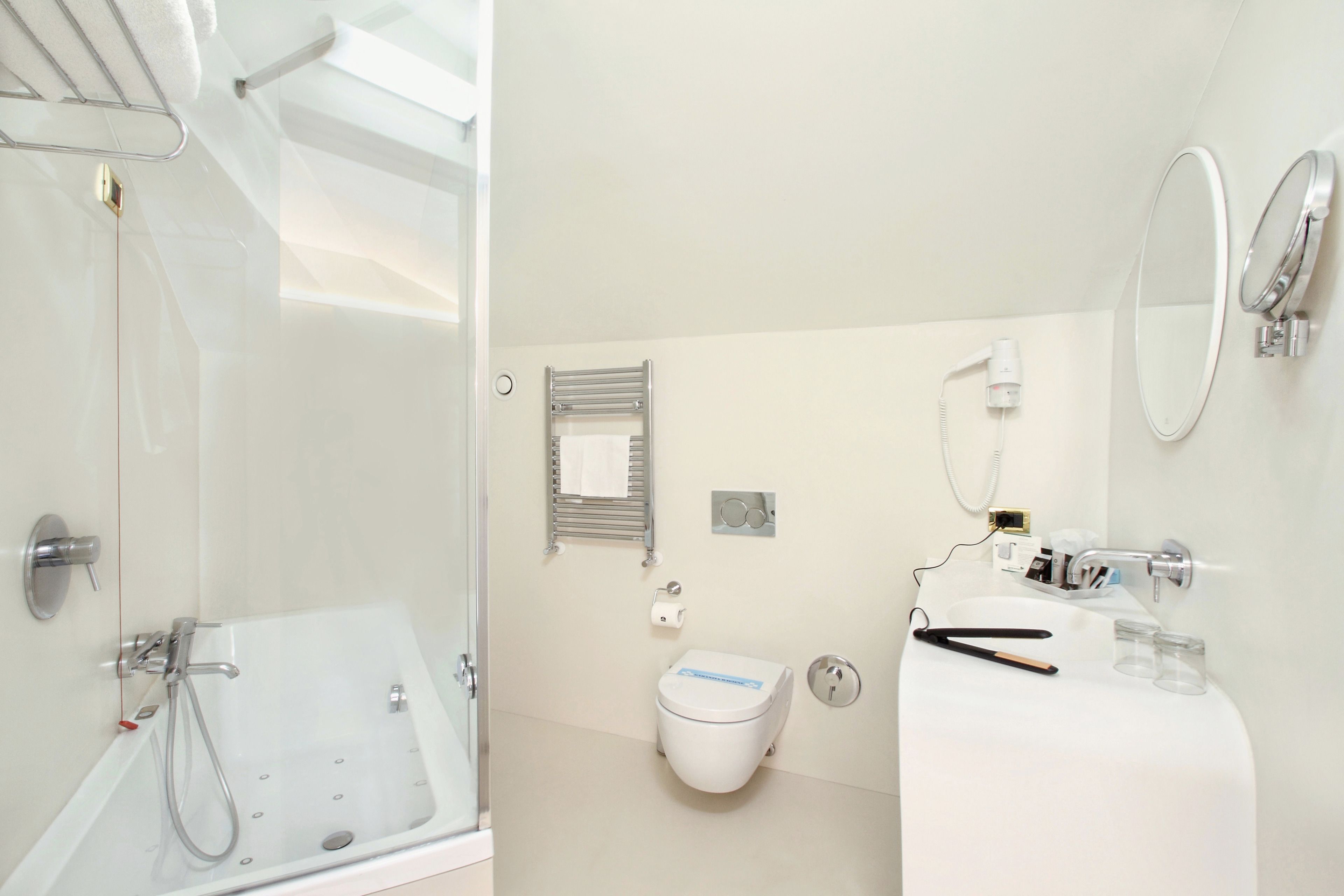 A modern bathroom with a bathtub, toilet, and sink.