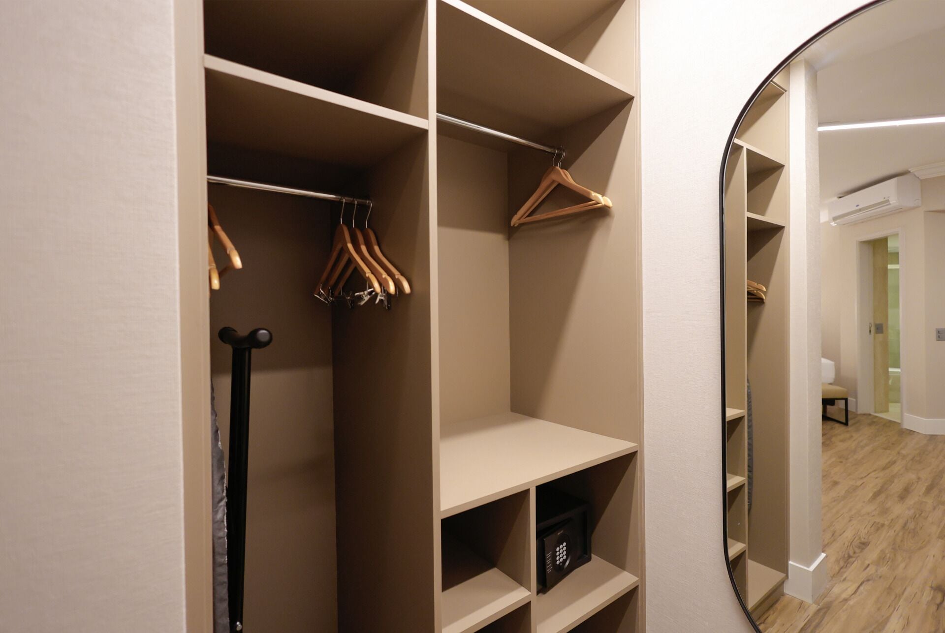 A walk-in closet with multiple shelves, a hanging rack, and a shoe rack.