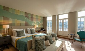 A hotel room with a bed, a desk, a chair, and a large window with a city view. - Pestana Vintage Porto Hotel & World Heritage Site (Porto)