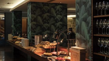 Un buffet proposant une variété de plats, un coin café et un présentoir à vin.