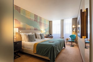 A hotel room with a large bed, a desk, a chair, and a map on the wall. - Pestana Vintage Porto Hotel & World Heritage Site (Porto)