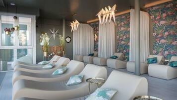 Relax in this stylish lounge area with curved sofas, decorative pillows, and a vibrant mural.