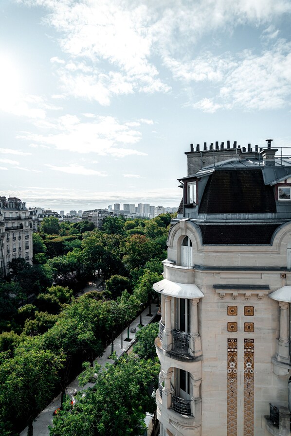 A historic building with ornate architecture, including a balcony and decorative tiles.