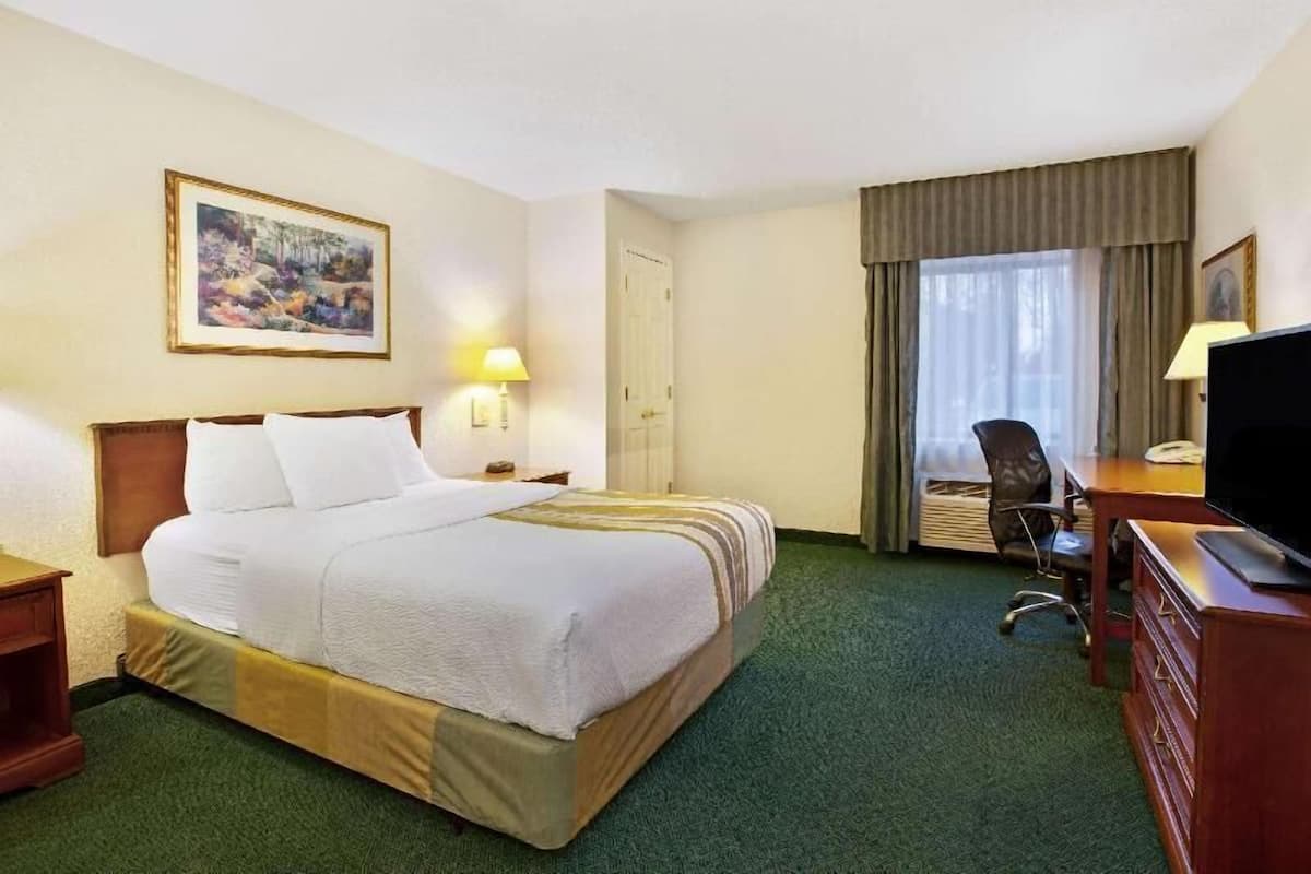 Premium bedding, desk, laptop workspace, blackout drapes