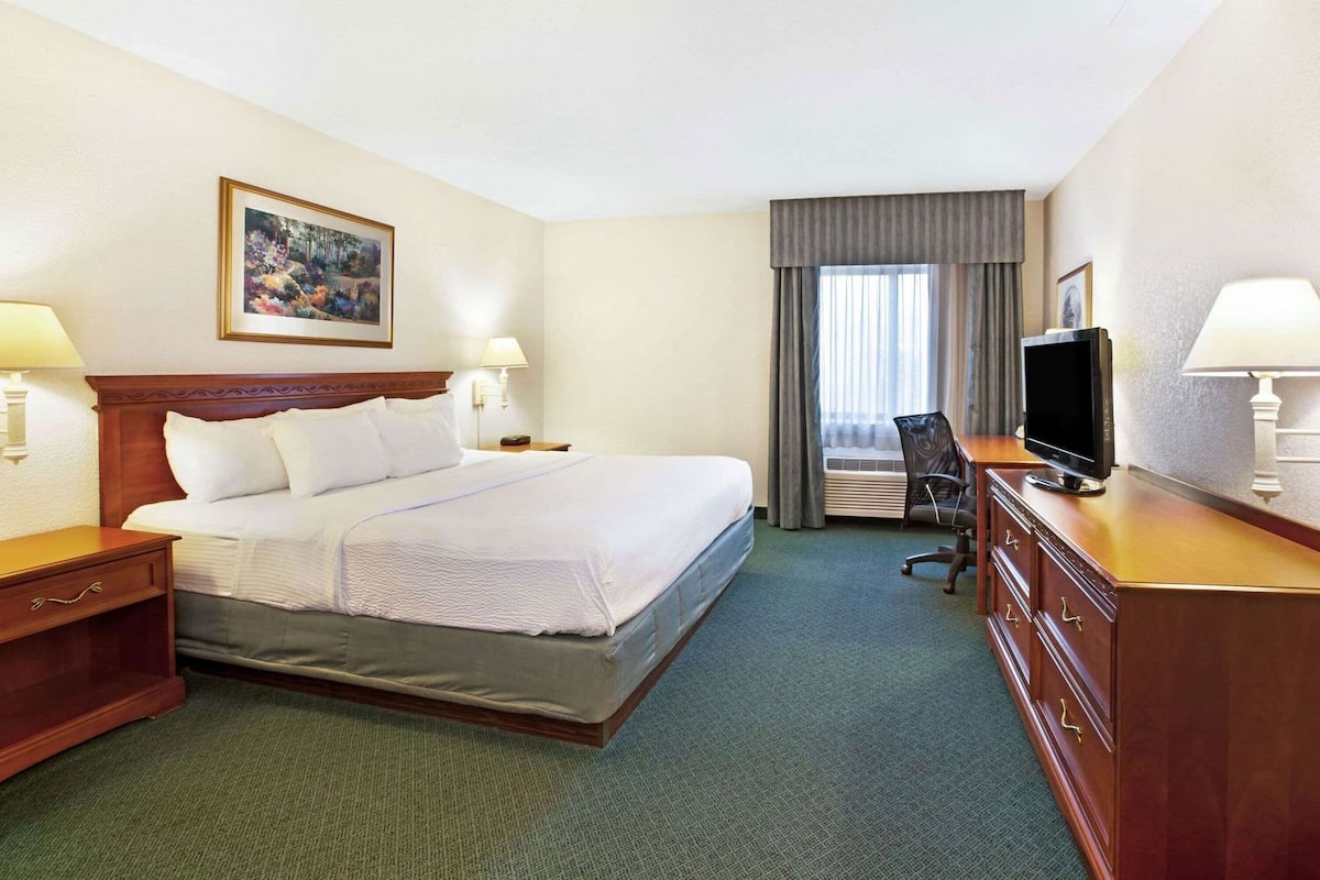 Premium bedding, desk, laptop workspace, blackout drapes