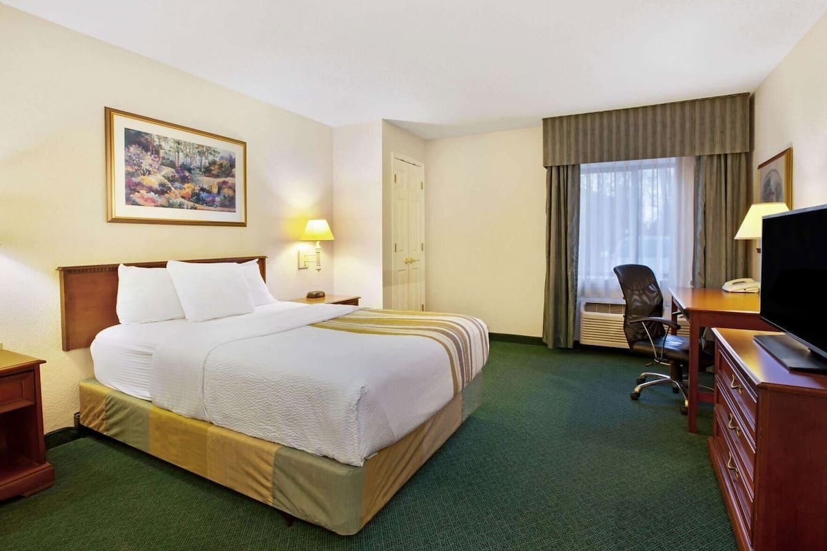 Premium bedding, desk, laptop workspace, blackout drapes