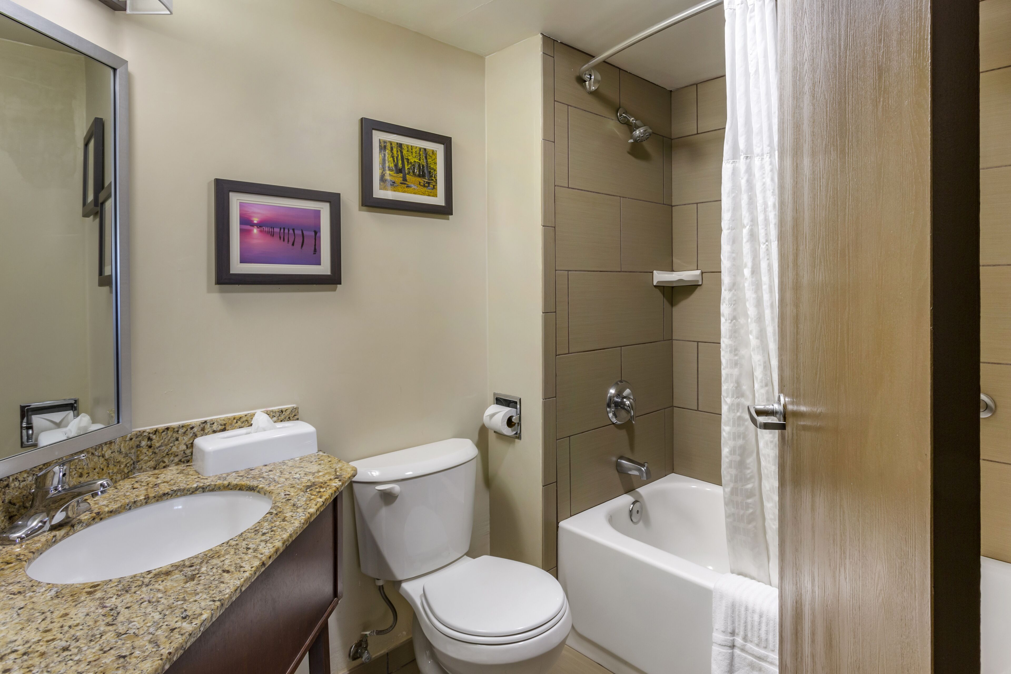 A bathroom with a sink, toilet, and bathtub.