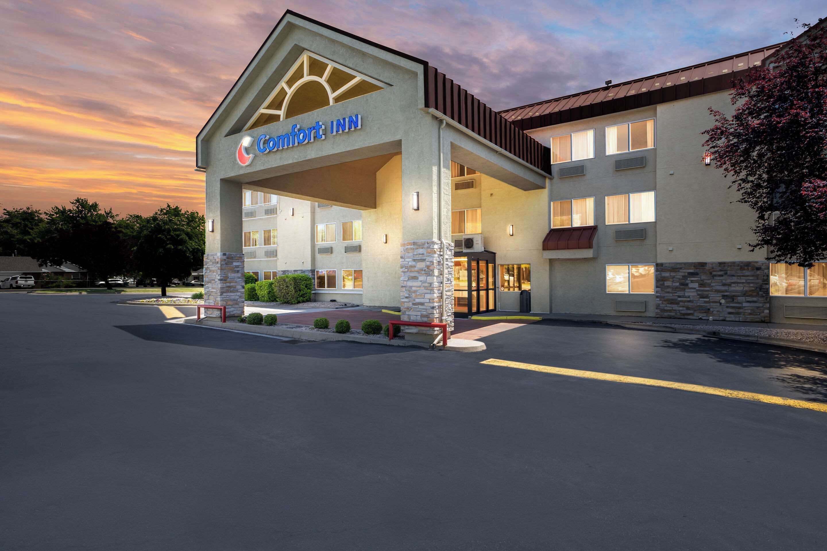 A Comfort Inn hotel with a modern design, featuring a prominent entrance and multiple windows.