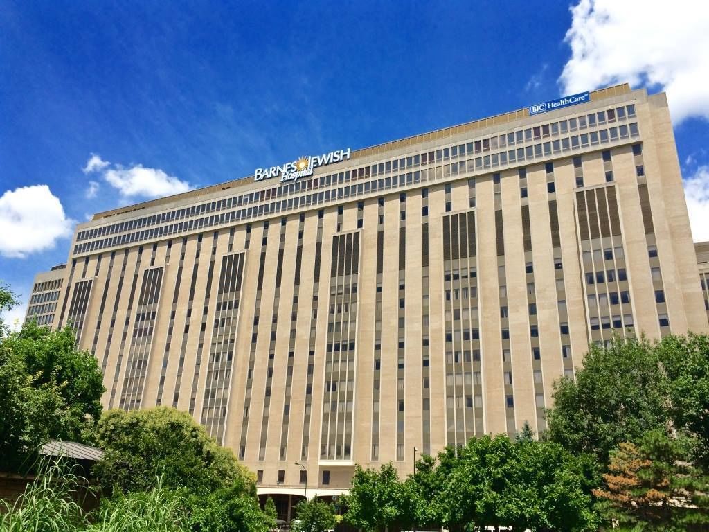 A large, modern building with a prominent sign reading "Barnes & Noble Hospital".