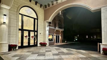 Enter through the grand arched doorway into a beautifully designed space.