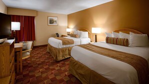 A hotel room with two beds, a desk with a chair, a television, and a painting on the wall. - Best Western Martinsville Inn (Martinsville)