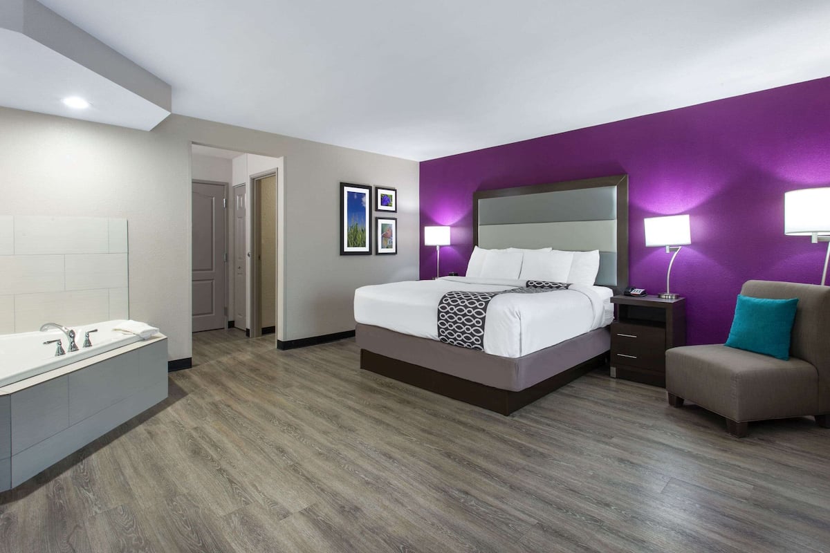 deluxe room, 1 king bed, non smoking, jetted tub | desk, laptop workspace, blackout curtains, iron/ironing board