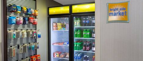 A vending machine with snacks and a refrigerator stocked with beverages.