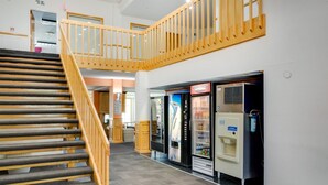 A staircase with wooden railings leading to a second-floor area. - Motel 6 Richmond, IN (Richmond)
