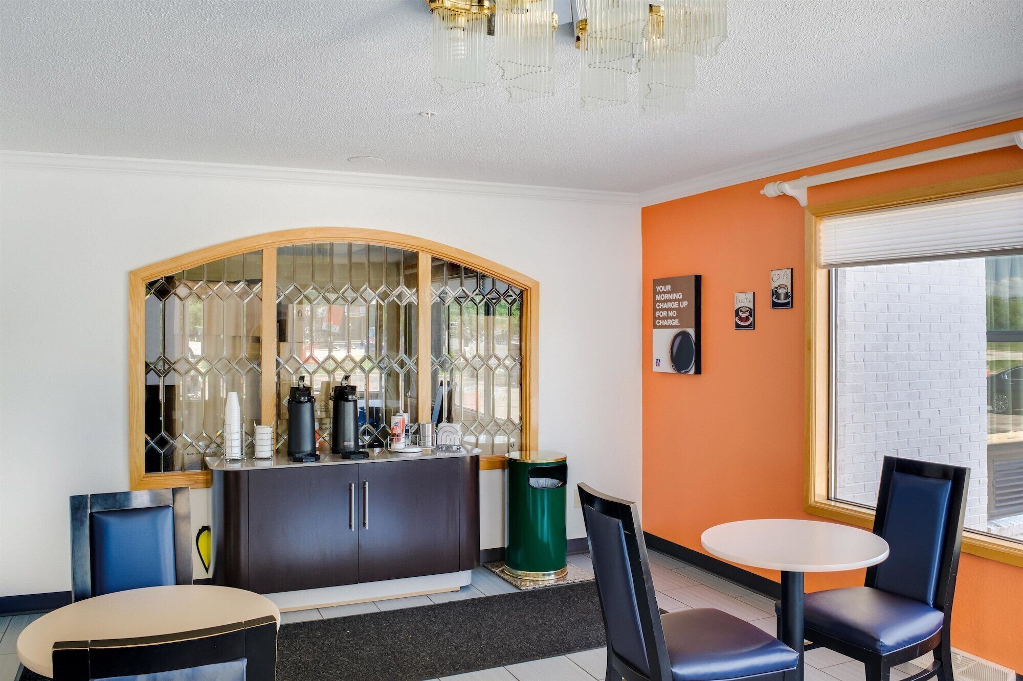 A bar area with a counter, stools, and a decorative glass partition.