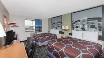 A hotel room with two beds, a desk, a chair, a TV, and a large window with a view.