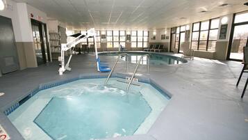 Swimmers can enjoy the rectangular pool surrounded by a tiled deck and two diving boards.