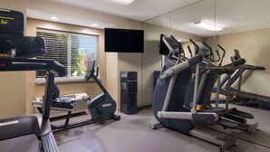 A gym with treadmills, an elliptical, and a stationary bike. - Sleep Inn Erie near Sports Center (Erie)