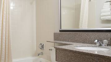 A bathroom with a toilet, sink, and shower.