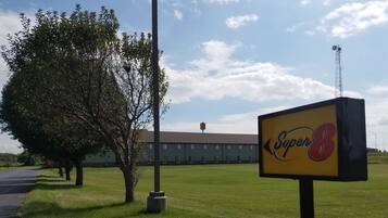 Welcome to Super 8, where a single post supports the hotel's bold sign.