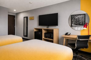 A hotel room with two beds, a desk, a flat-screen TV, a telephone, and a mirror. - Super 8 by Wyndham Champaign (Champaign)