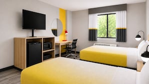 A hotel room with two beds, a desk, a television, a microwave, and a window with curtains. - Super 8 by Wyndham Champaign (Champaign)
