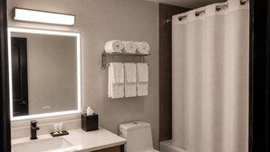 A modern bathroom with a white sink, a toilet, and a shower curtain. - Super 8 by Wyndham Champaign (Champaign)