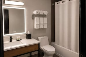A modern bathroom with a white sink, a toilet, and a shower area. - Super 8 by Wyndham Champaign (Champaign)