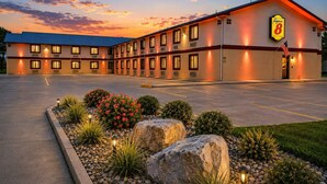 A Super 8 motel with a parking lot and landscaped garden. - Super 8 by Wyndham Champaign (Champaign)