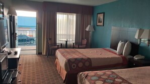 A hotel room with two beds, a desk, a chair, a table, and a balcony with a view. - FairBridge Inn Express Stuttgart (Stuttgart)