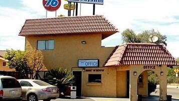 A building with a sign for 'Days Inn' and '76' indicating a highway nearby. There are two 'Office' signs on the building.