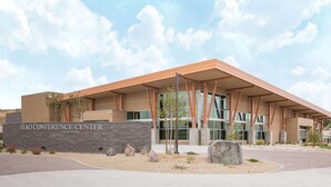 The Elko Conference Center with a modern architectural design, featuring a prominent entrance and a landscaped area with rocks and plants. - Super 8 by Wyndham Elko (Elko)